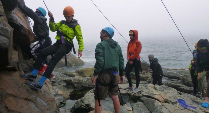 young teens learn rock climbing in maine